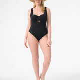 A model is wearing a black one-piece swimsuit with a deep v-neckline and sleeveless design and a hat