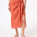 A woman wearing peach wrap skirt