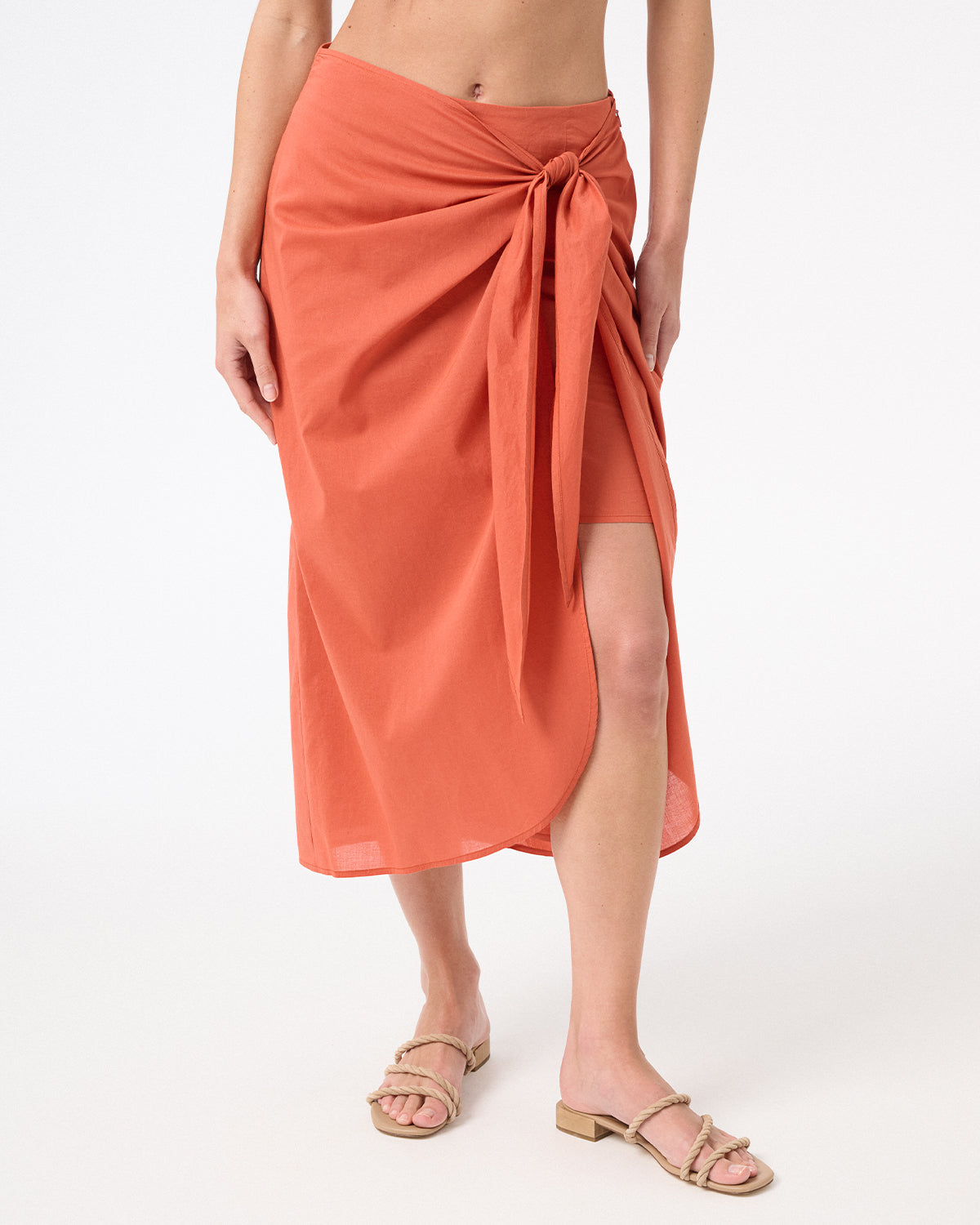 A woman wearing peach wrap skirt