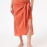 A woman wearing peach wrap skirt