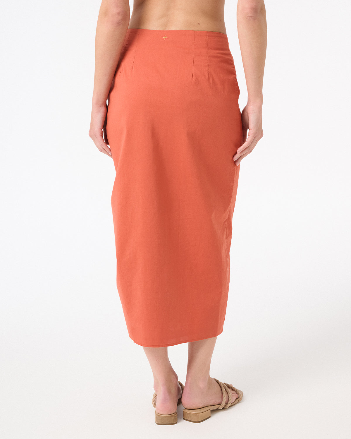 A woman wearing peach wrap skirt