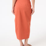 A woman wearing peach wrap skirt
