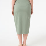 A woman wearing green wrap skirt with black swimsuit underneath
