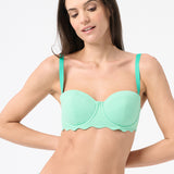 A woman wearing green bikini top