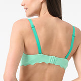 Back of woman wearing green bikini top