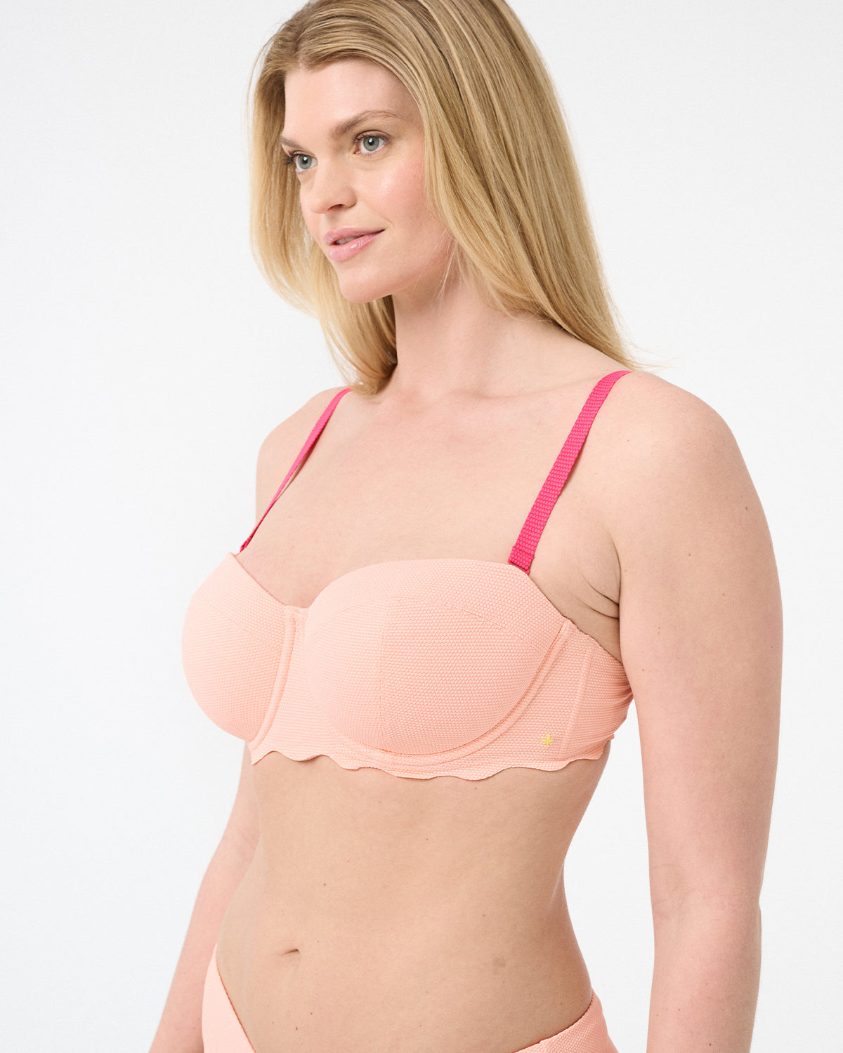 A bikini top in color hibiscus with pink straps