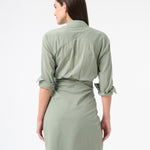 Back of a woman wearing a long sleeved green sea salt wrap dress