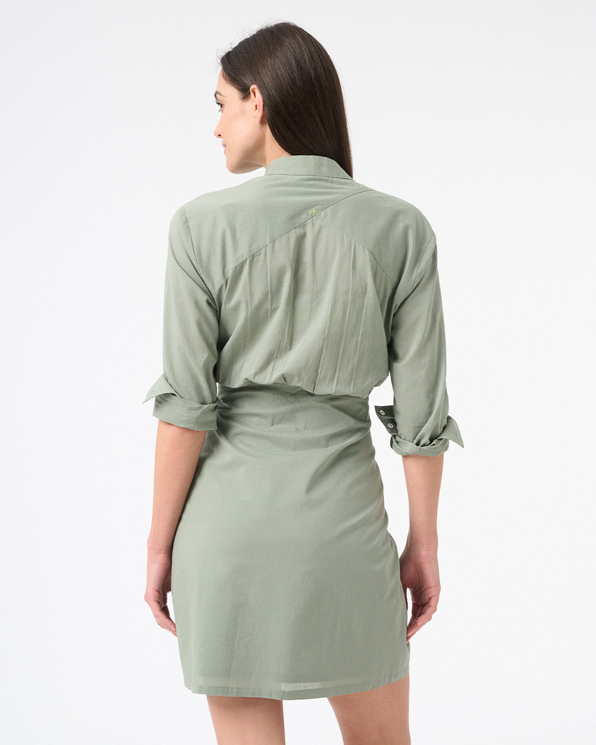 Back of a woman wearing a long sleeved green sea salt wrap dress