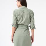 Back of a woman wearing a long sleeved green sea salt wrap dress