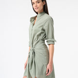 Woman wearing green sea salt wrap dress with long sleeves and buttons down the front