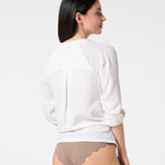 Back view of white gauze button-down shirt with rolled sleeves, paired with Cocoa bikini bottoms for a relaxed resort style