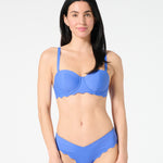 Woman wearing a blue grotto bikini set on a white background