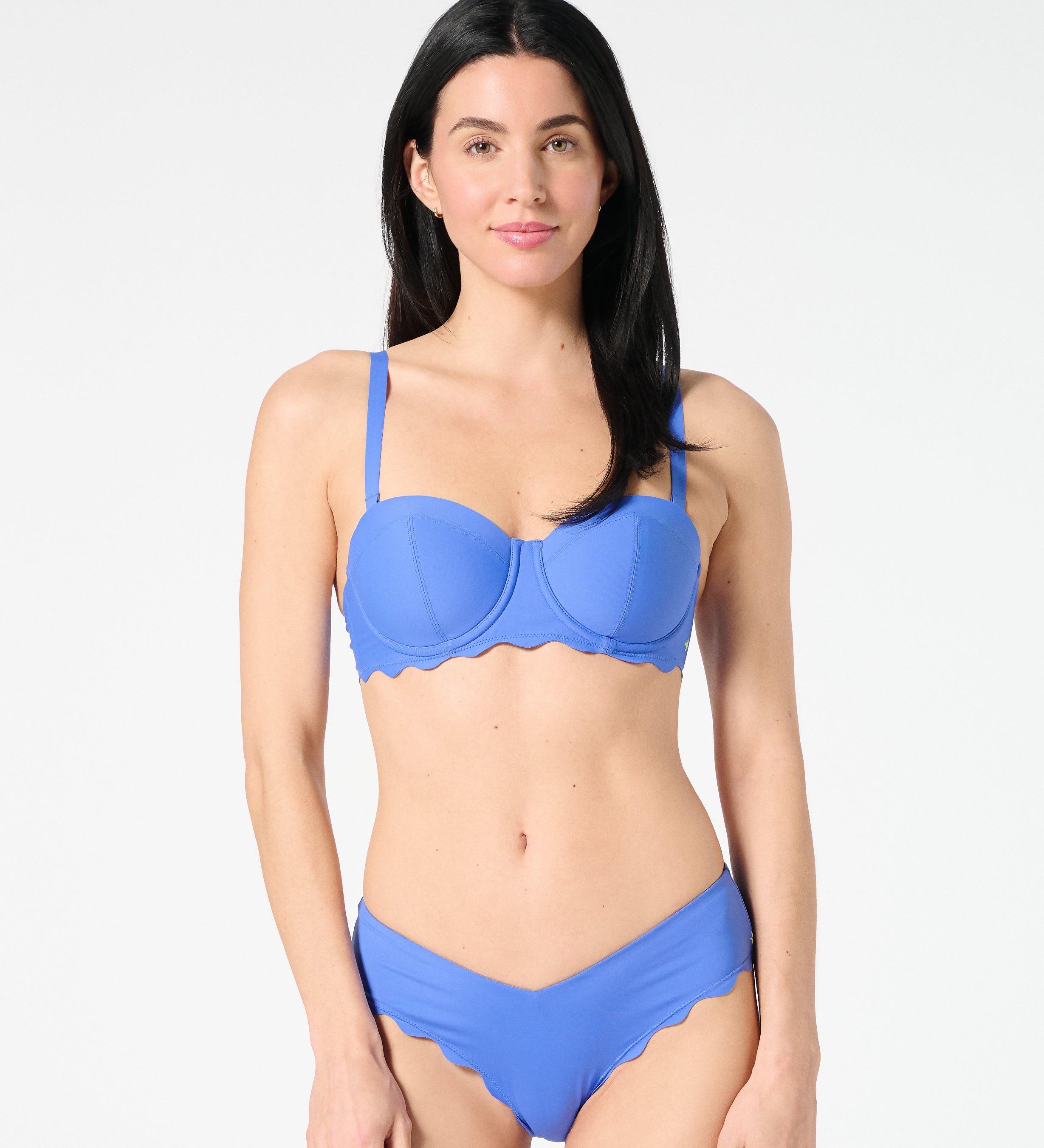 Woman wearing a blue grotto bikini set on a white background