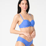 Three-quarter view of blue balconette bikini top with sculpting bra-sized cups and adjustable convertible straps