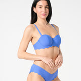 Three-quarter view of blue balconette bikini top with sculpting bra-sized cups and adjustable convertible straps