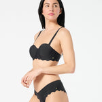 Woman in black balconette bikini top with supportive underwire cups and adjustable convertible straps