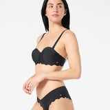 Woman in black balconette bikini top with supportive underwire cups and adjustable convertible straps
