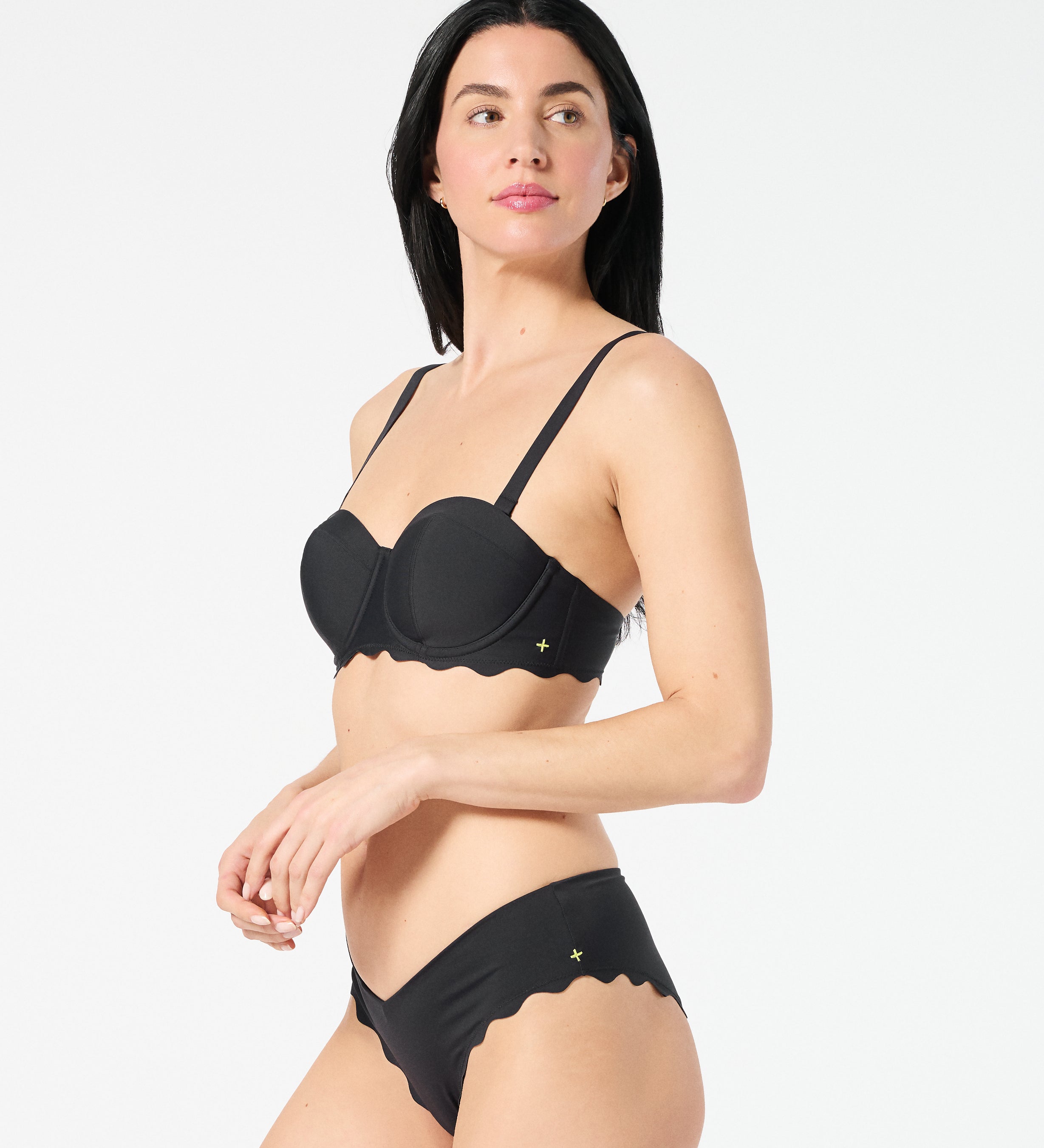 Woman in black balconette bikini top with supportive underwire cups and adjustable convertible straps