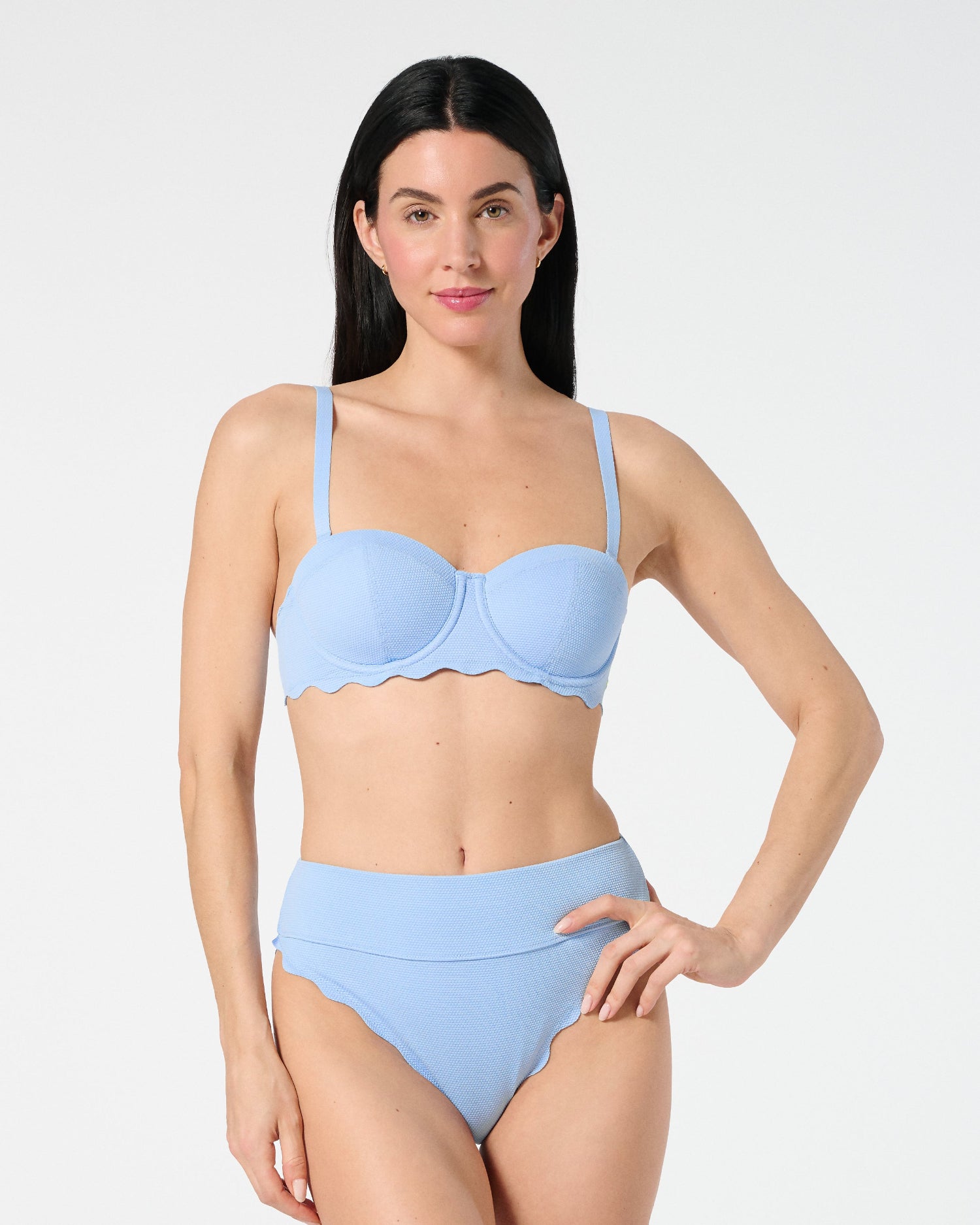 Woman wearing Salt Air textured balconette bikini top with underwire support, paired with sculpting high-waisted Sia bottoms with scalloped edges