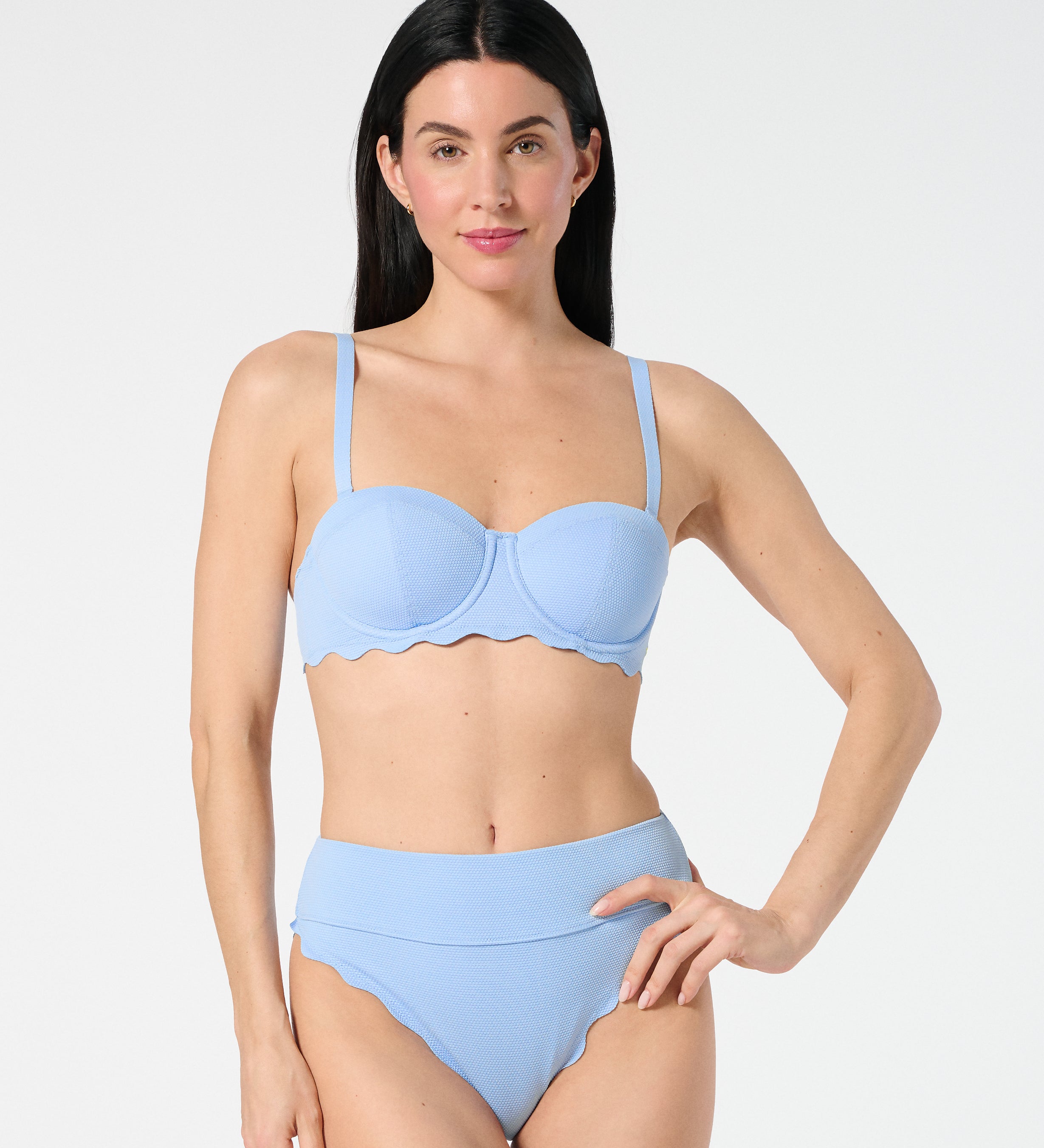 Woman wearing Salt Air textured balconette bikini top with underwire support, paired with sculpting high-waisted Sia bottoms with scalloped edges