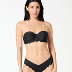 Woman wearing black strapless balconette bikini top with a supportive bra-sized fit and seamless smooth finish