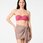 Woman wearing textured Hibiscus balconette bikini top with bra-sized support, paired with a neutral swim sarong for chic beach styling